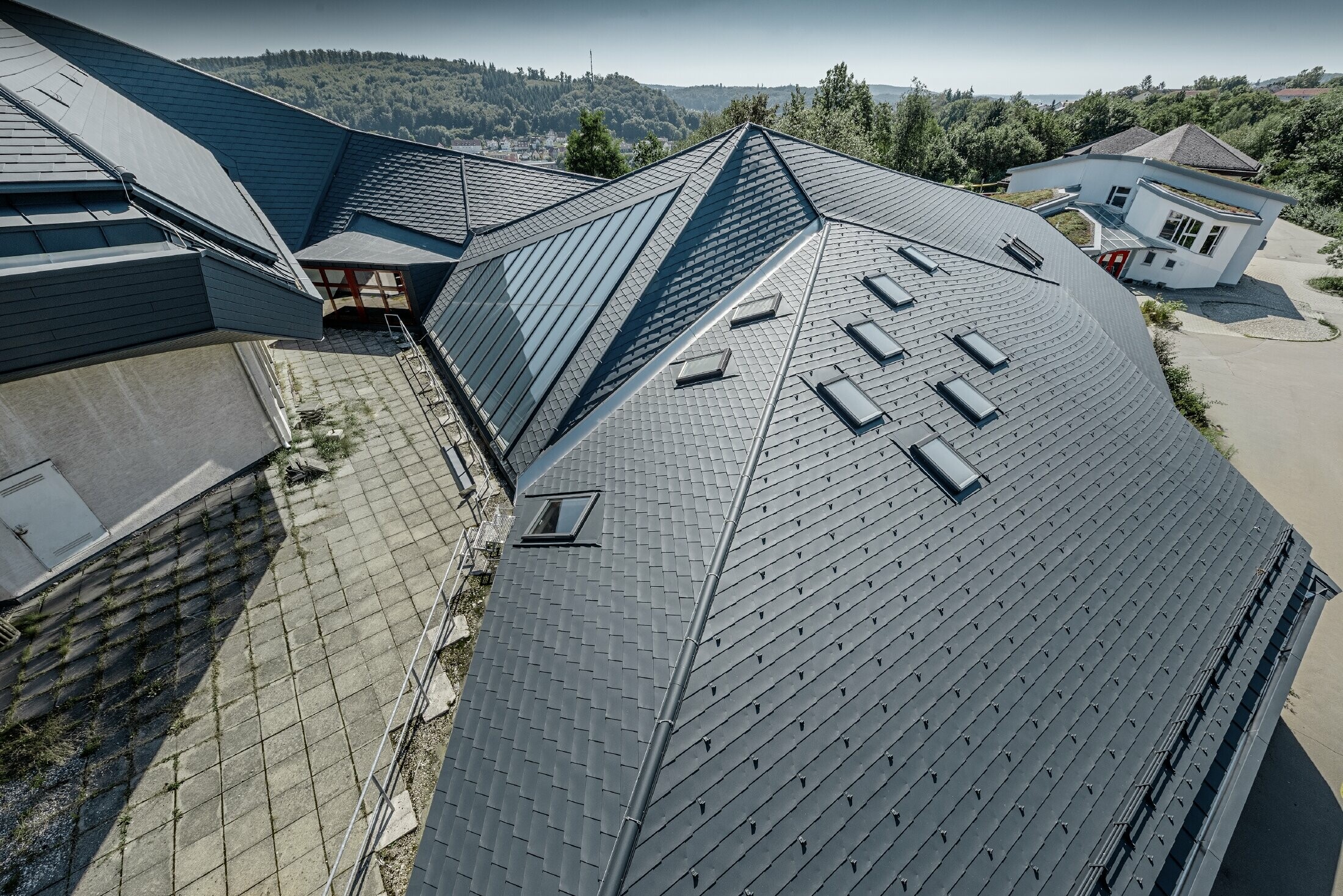 École Waldorf de Heidenheim au toit rénové — L’importante toiture aux nombreux angles, recoins et inclinaisons a été réalisée avec des bardeaux PREFA anthracite