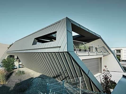 Zeer modern vrijstaand huis met ongewone architectuur, met een schuine felsgevel van aluminium van PREFA in lichtgrijs